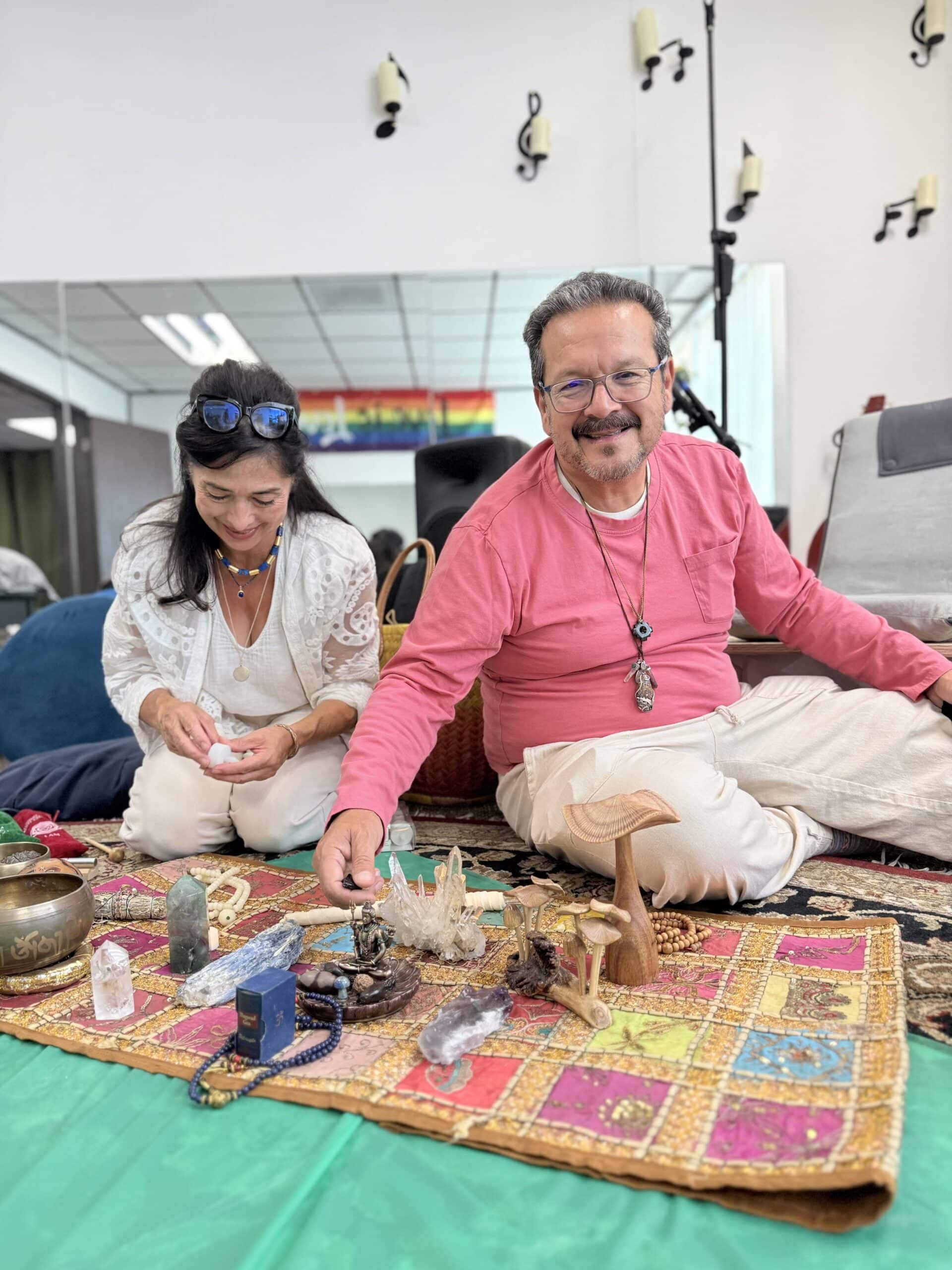 Facilitators leading a healing ceremony with an altar of sacred objects