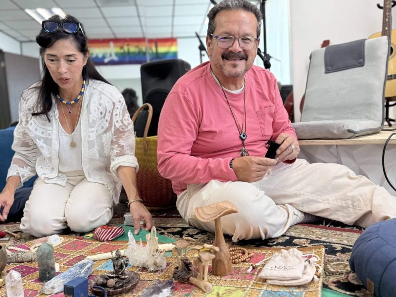 Facilitators seated at a ceremonial altar during a healing gathering