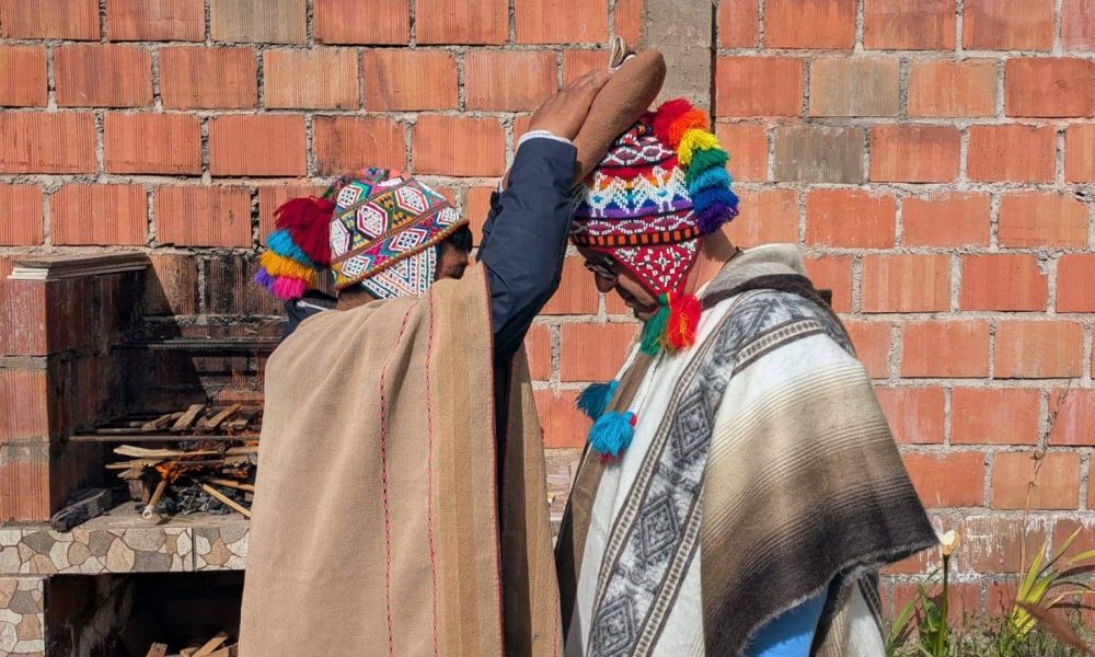 Andean healers in traditional ponchos performing a blessing ceremony
